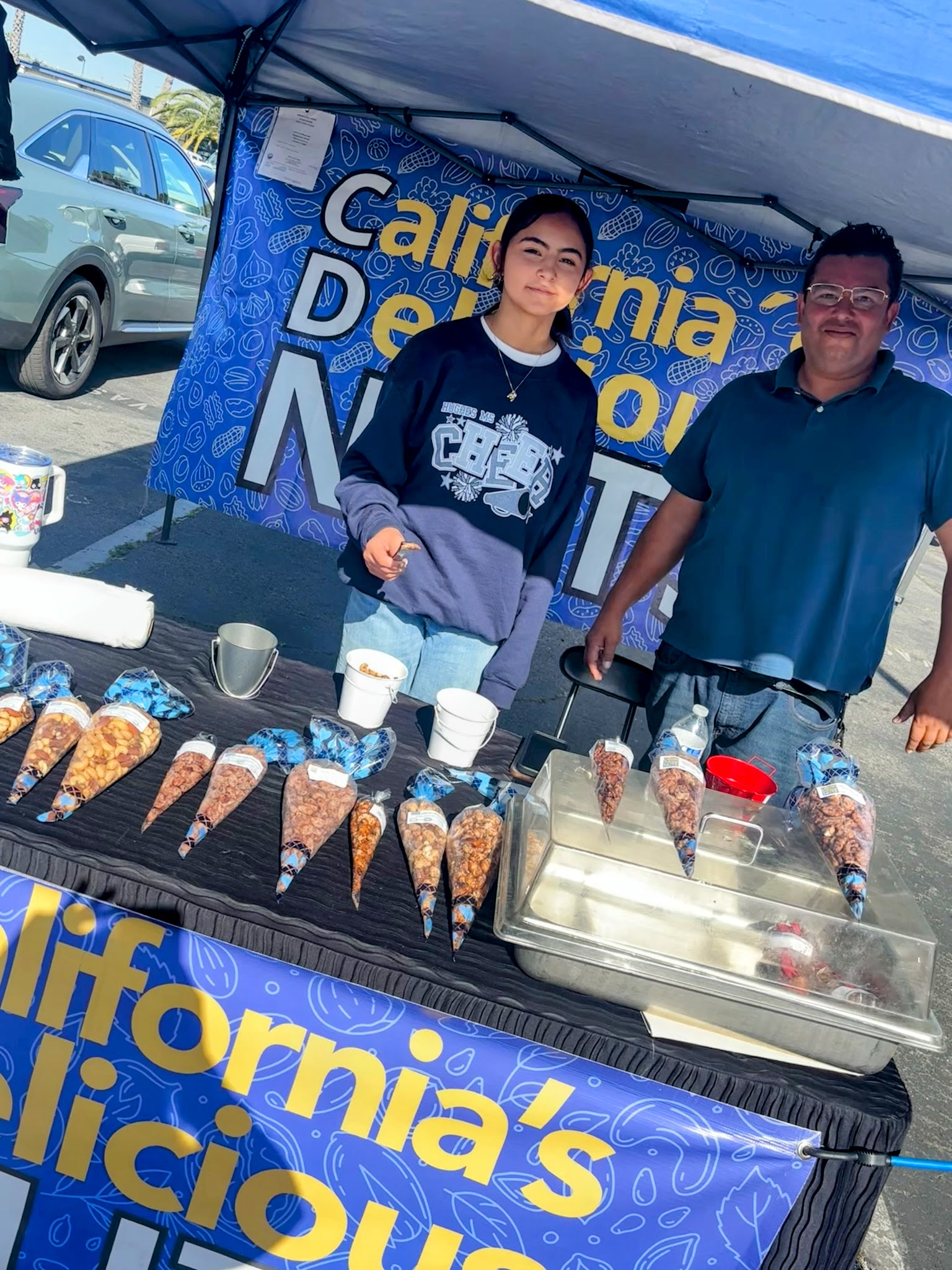 Family members serving roasted nut cones at the California's Delicious Nuts booth